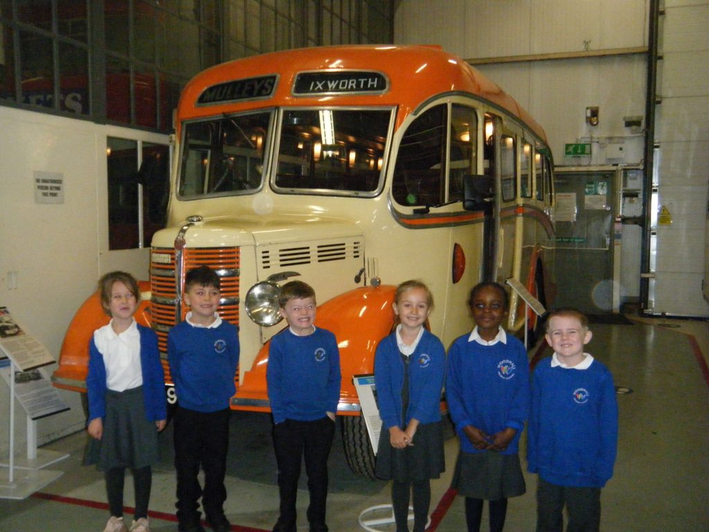 Year 1 pupils in front of an old Mulleys Ixworth bus